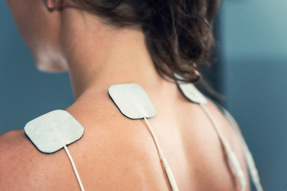 TENS electrodes treatment on shoulders